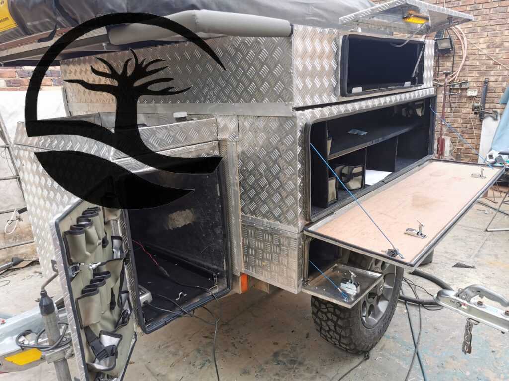 Completed Custom aluminum nosecone and nosecone door caddie installed during Remodeling of a B'rakah Camping trailer.