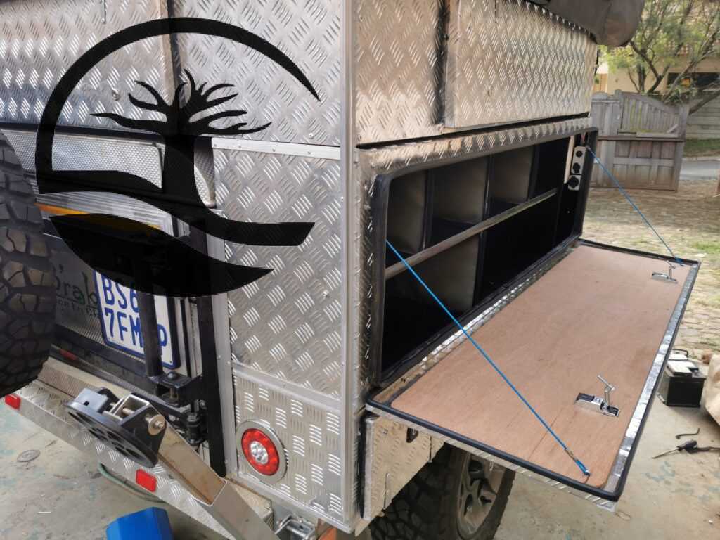 Completed Custom Steel shelving installed during Remodeling of a B'rakah Camping trailer with Aluminum treat plate boxes.