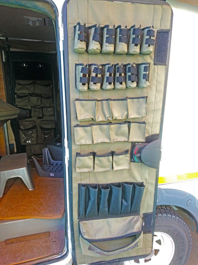 Canvas door caddie to hold mugs, glasses, kitchen utensils and other items fitted to the doors of a Jurgens XT Caravan.