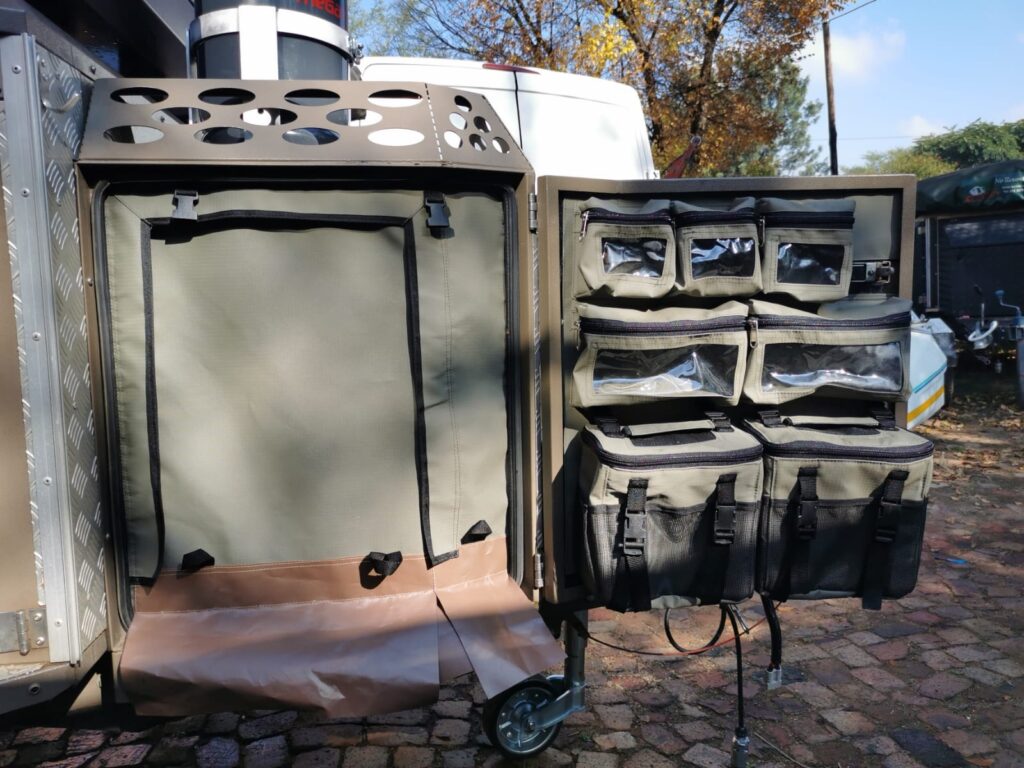 Nosecone door with fixed zipped bags and removable shower bags and a waterproof canvas door to keep the inside dry when showering.