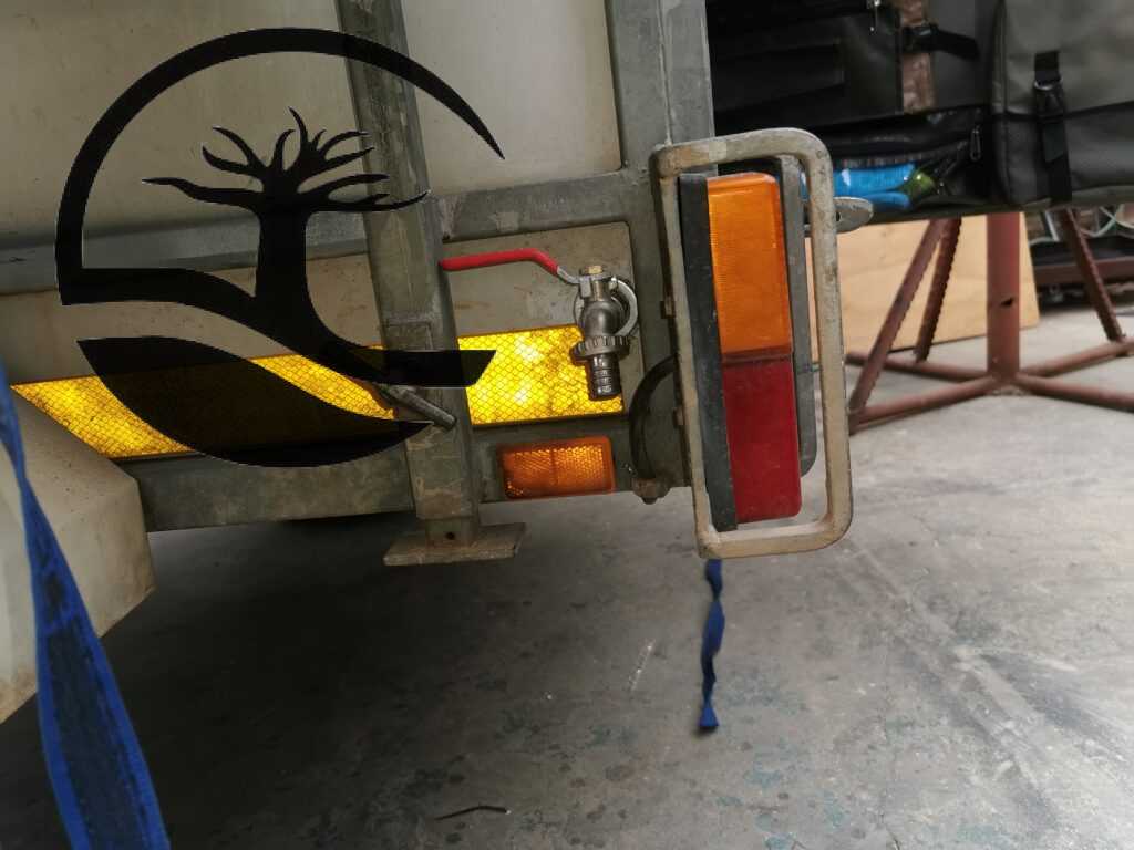 Exterior water tap supplying water from a custom fitted water tank as part of a full water system inside a Buzzard Camping trailer.