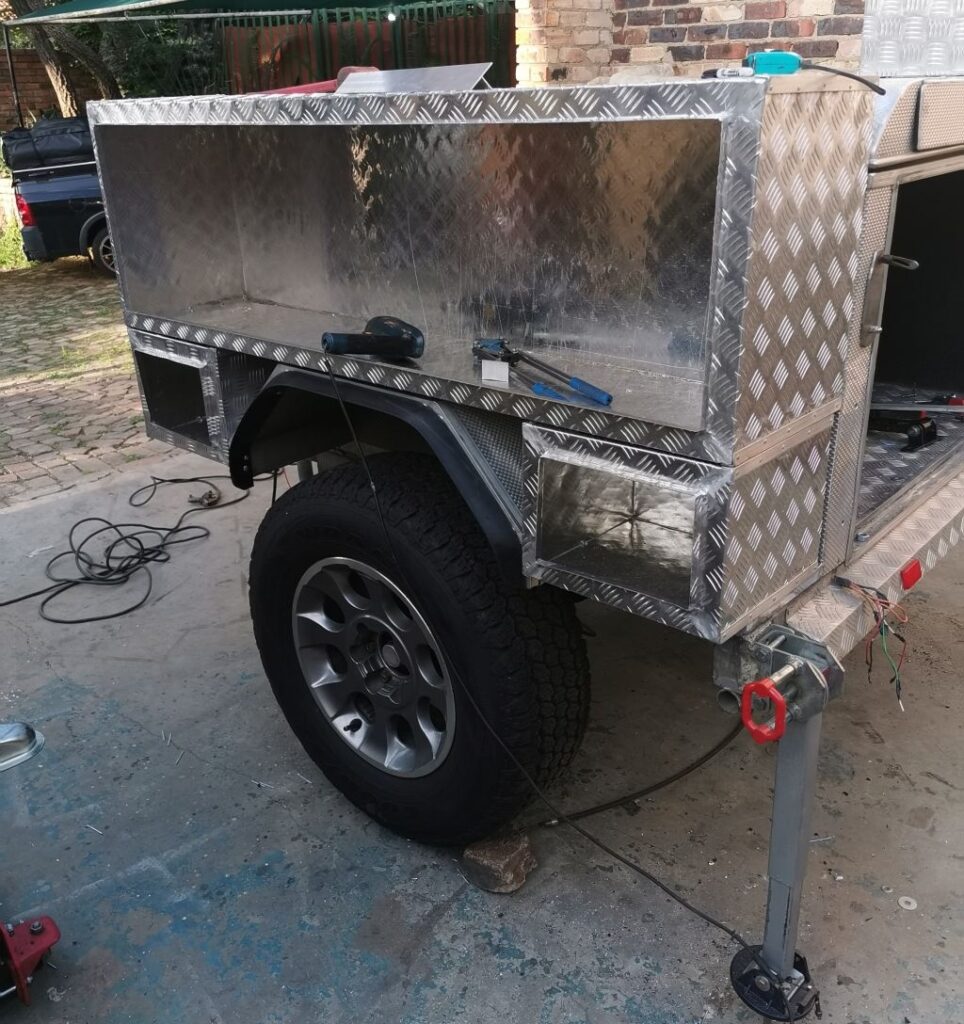 Installation of Custom aluminum side boxes during Remodeling of a B'rakah Camping trailer.