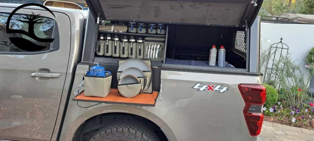 Custom Canvas caddies to hold Melamine plates and bowls, 4 x steel mugs and a percolator, Stanley flasks and dishcloths in an aluminum canopy for a Mazda LDV or bakkie.