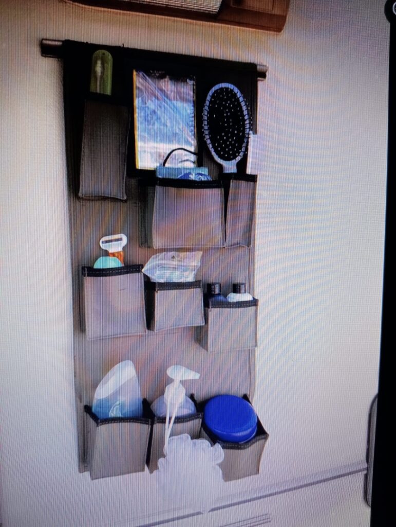 Custom Canvas Caddie for outside Shower tent to hold toothbrushes and toothpaste, hairbrush, soap, shavers and other personal hygiene products on the wall of a Jurgens XT Caravan.
