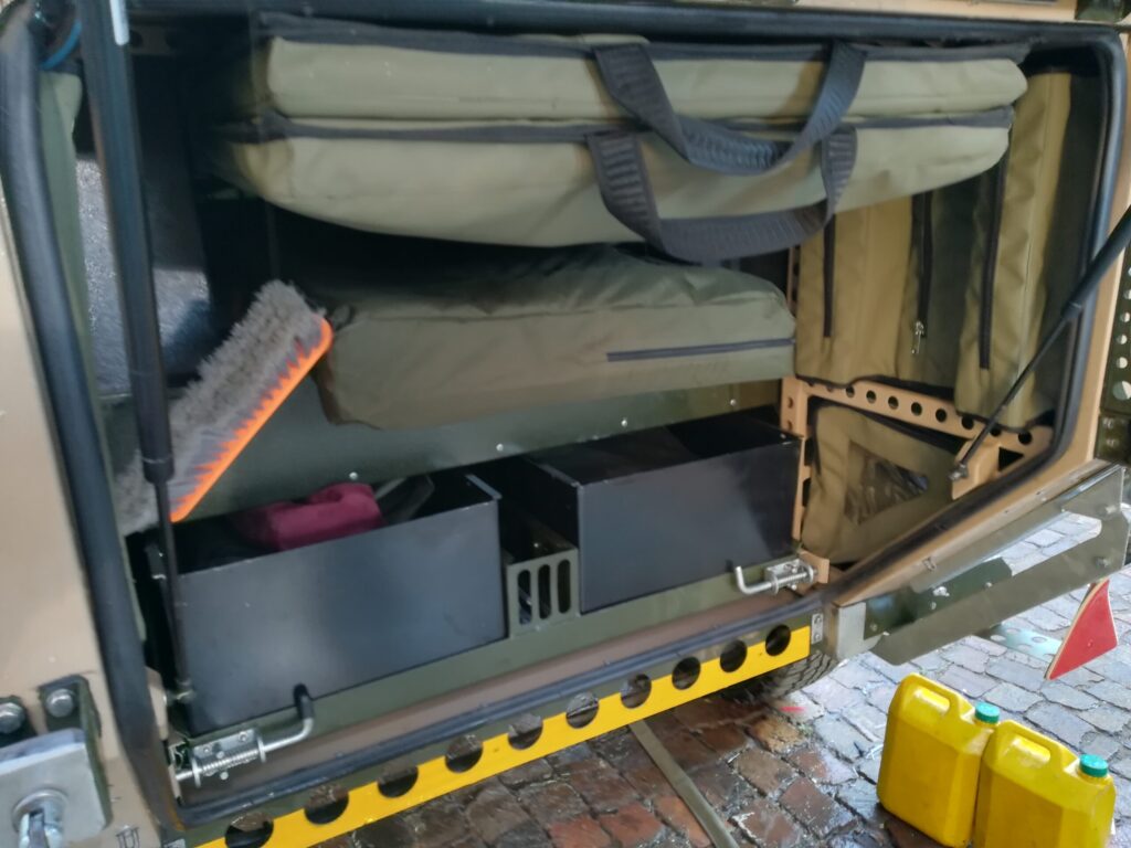 Custom Canvas bags to hold a Table, Solar panel and Awnings in the rear door compartment of a Conqueror Courage Trailer.