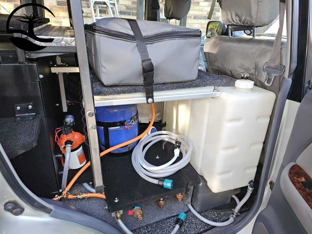 Custom Built Water and Geyser System for an overland vehicle built into an Expedition Built Toyota Prado. The geyser is stored insode a custom Canvas bag and strapped in during traveling.
